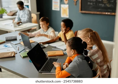 Person sitting on floor working on laptop